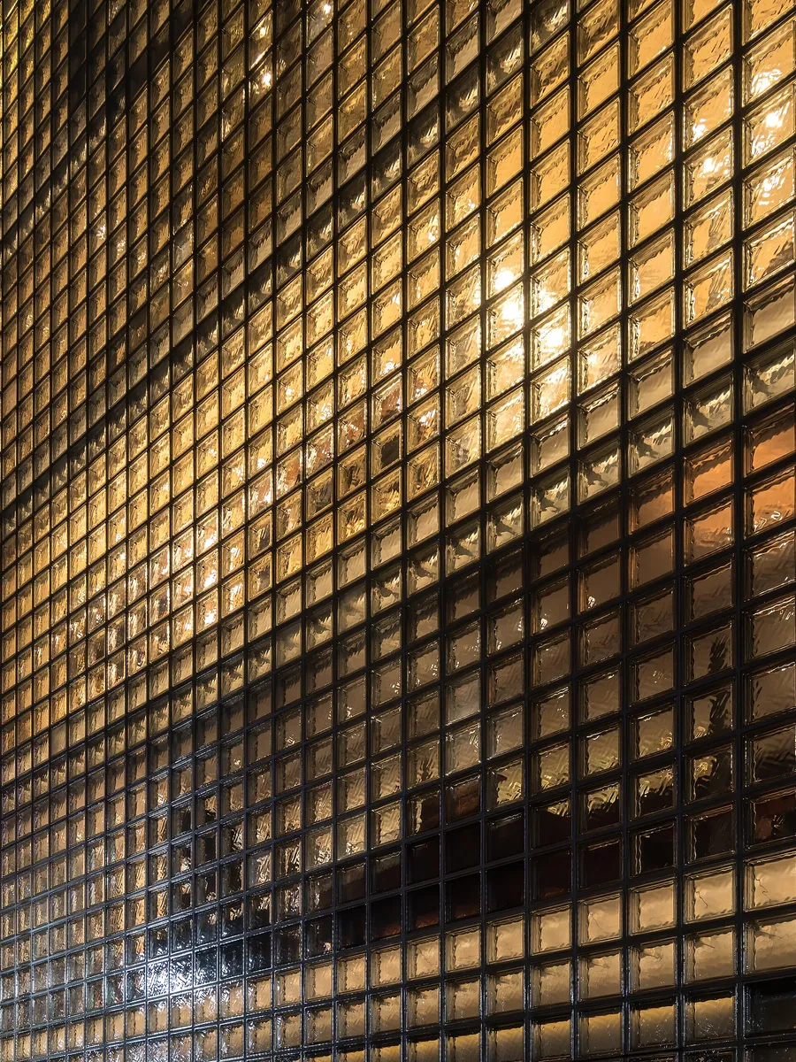 A glass-block facade lit up at night in Ginza, Tokyo